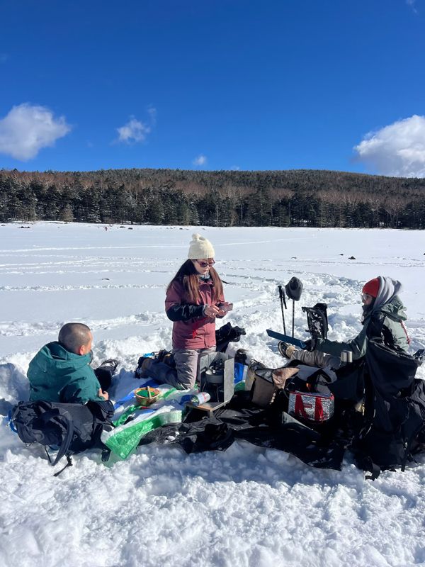 Guests having lunch on a frozen, snow-covered lake